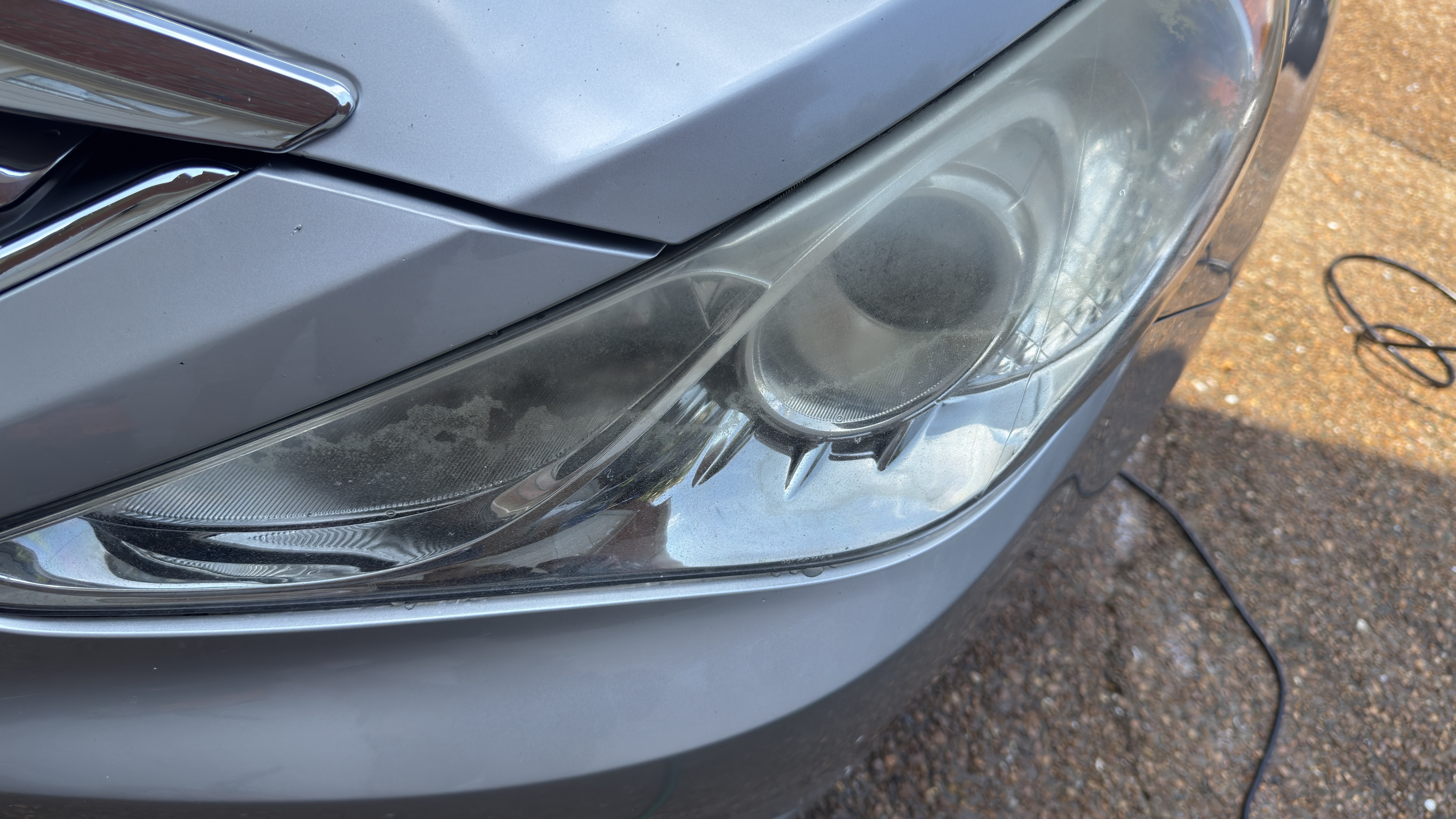 Before — cloudy oxidized headlight lens