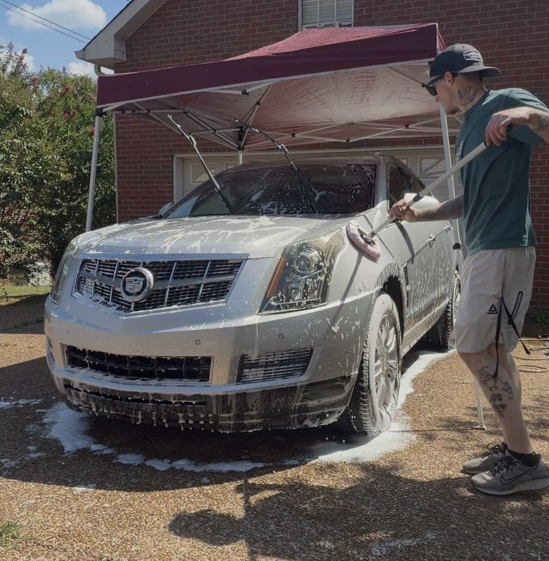 Jacob foaming a Cadillac SRX under a canopy