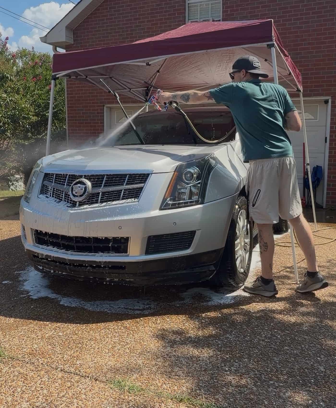 Jacob rinsing foam off a Cadillac SRX