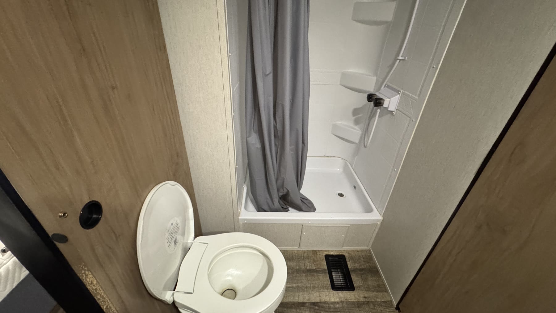 Camper bathroom with toilet and shower after cleaning