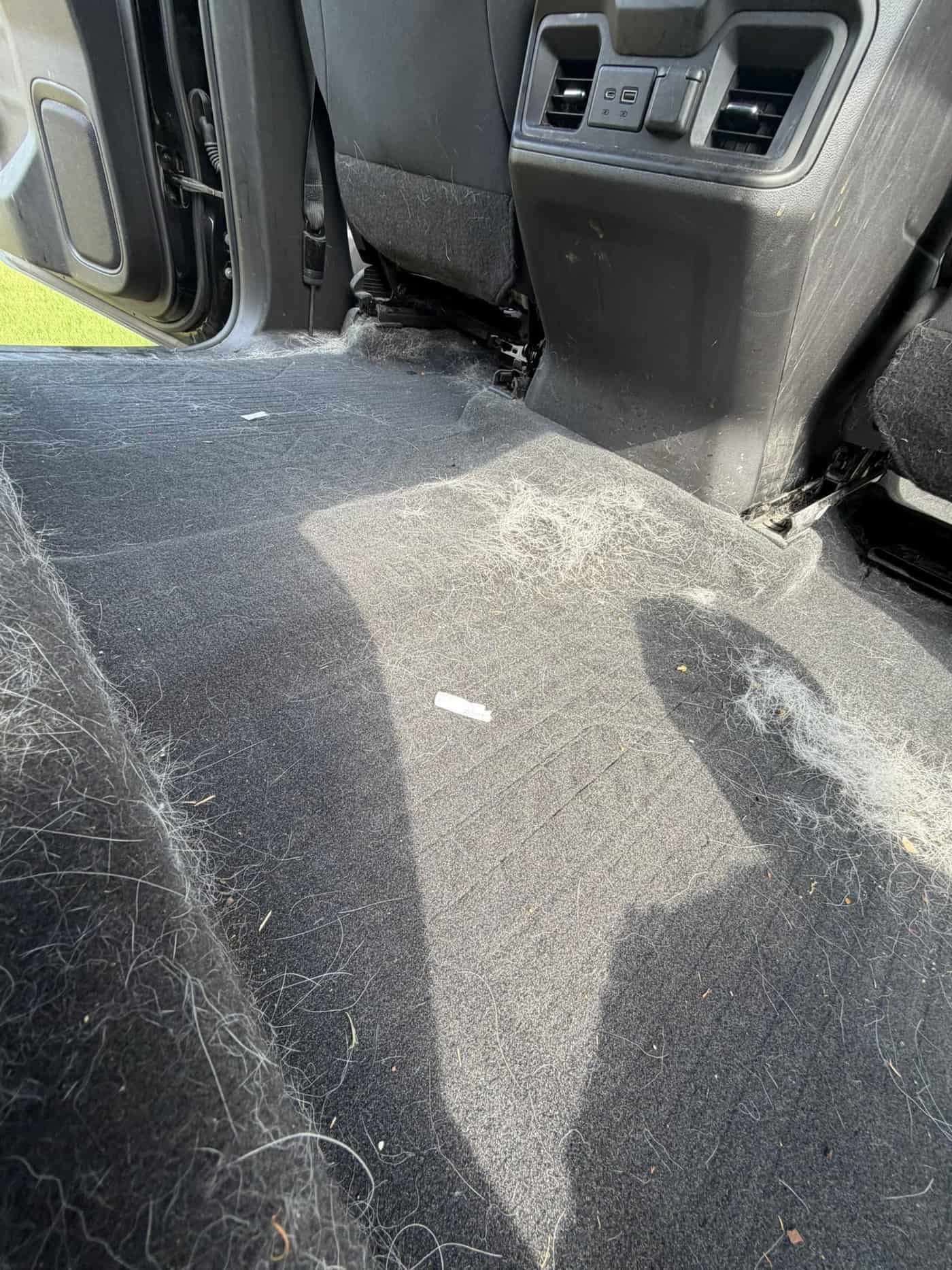 Chevy Silverado rear floor covered in dirt before cleaning