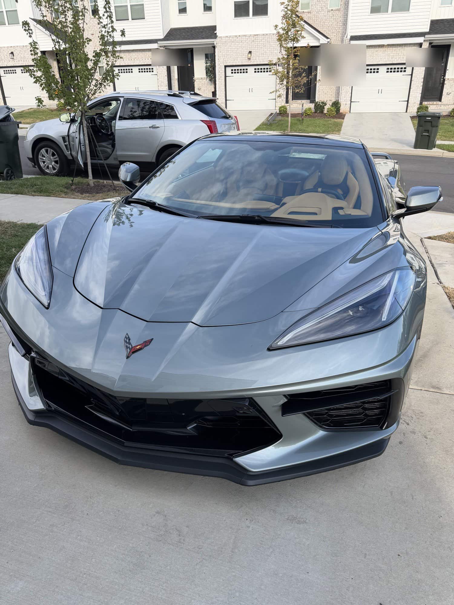 Front of a gray Corvette C8 after a wash
