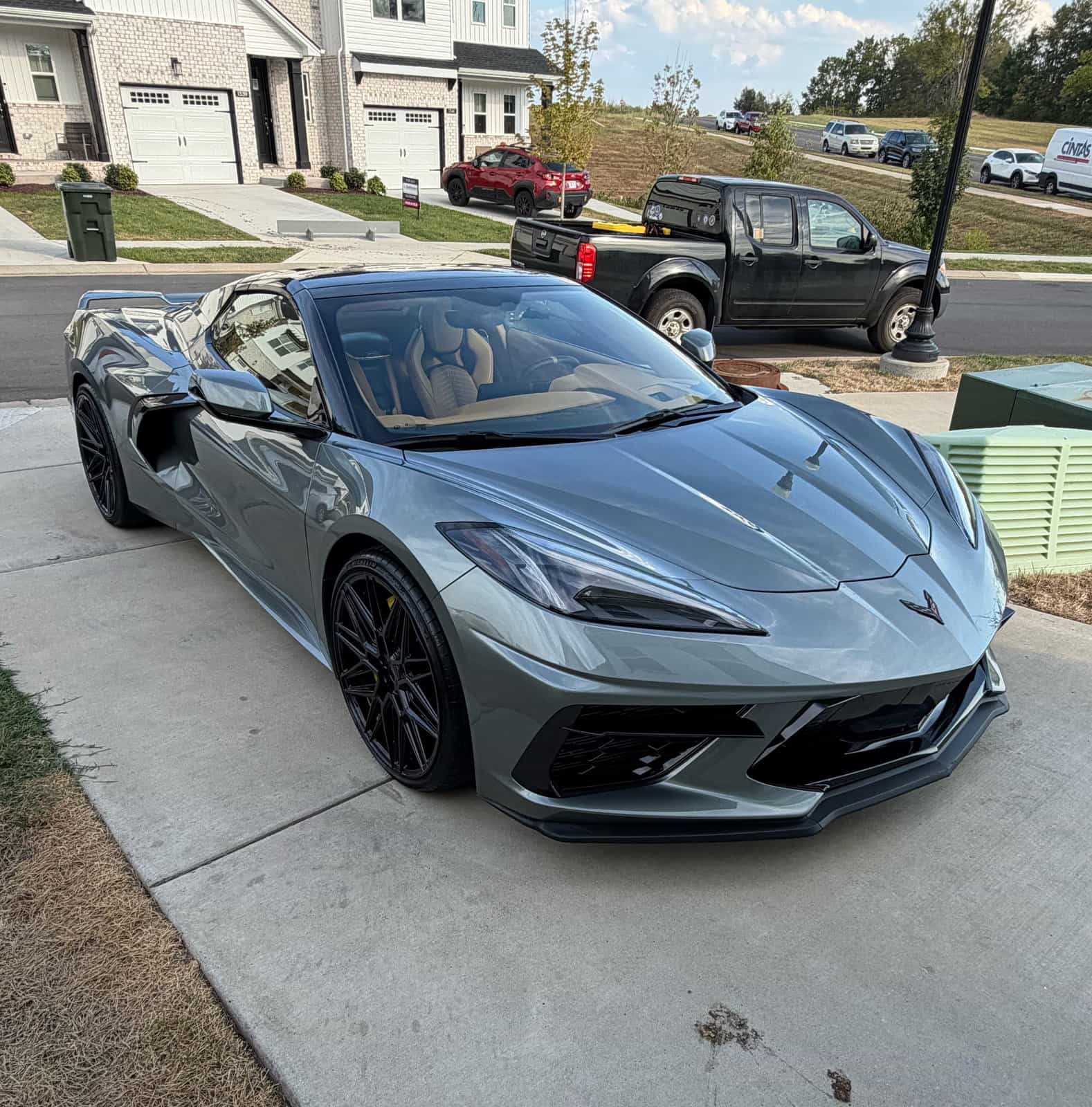 Gray Corvette C8 parked in a driveway after a full detail