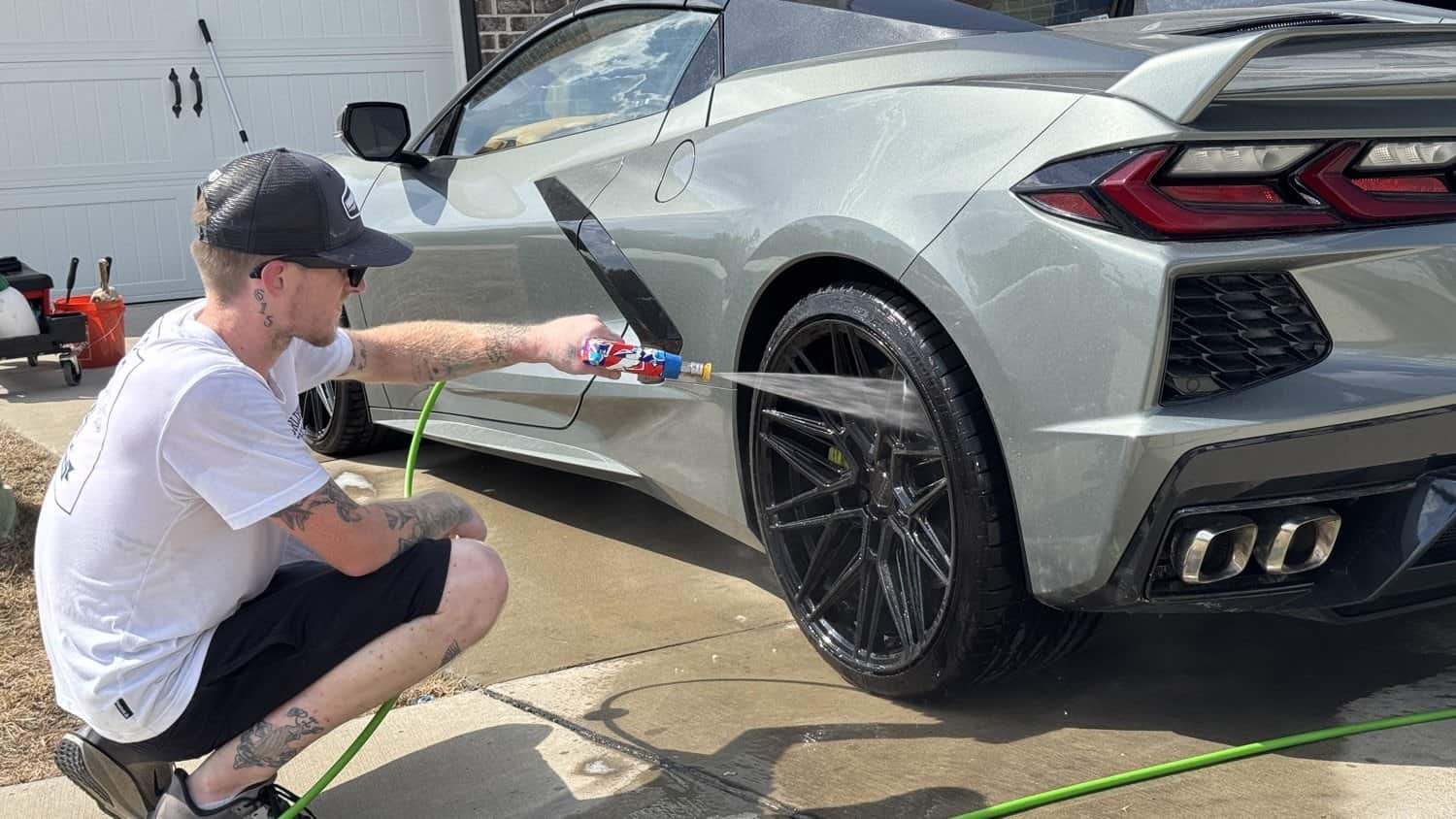 Jacob pressure washing a Corvette C8 wheel
