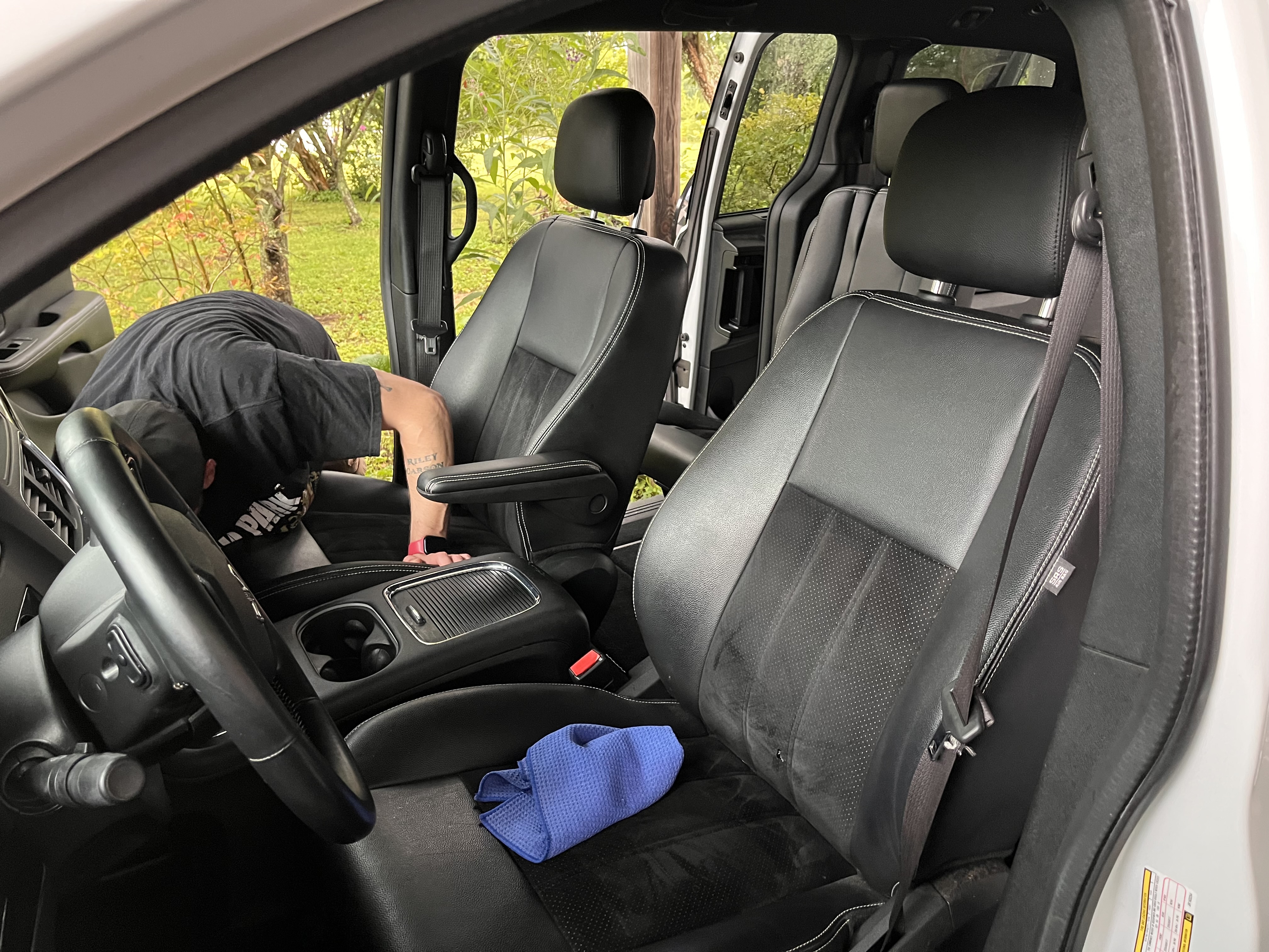 Dylan Embry deep-cleaning interior floorboards and console