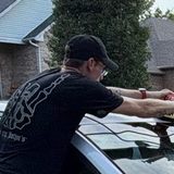 Dylan wiping down a car window
