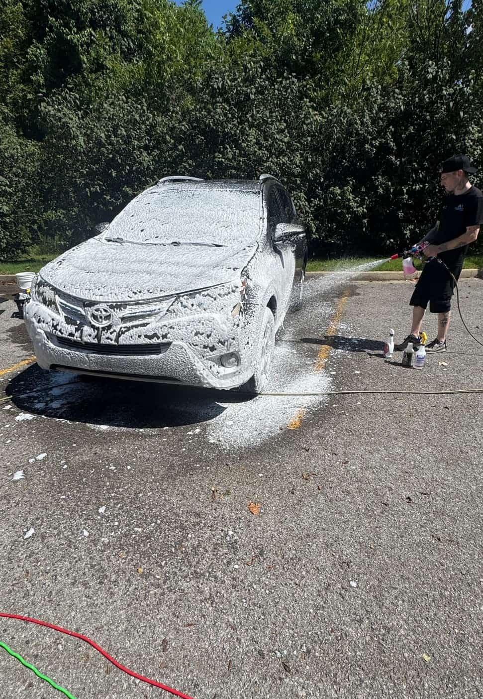Car covered in foam during a driveway wash