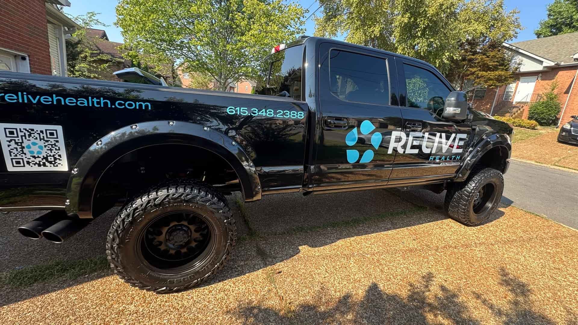 Black Ford F-250 work truck from the side after a full detail
