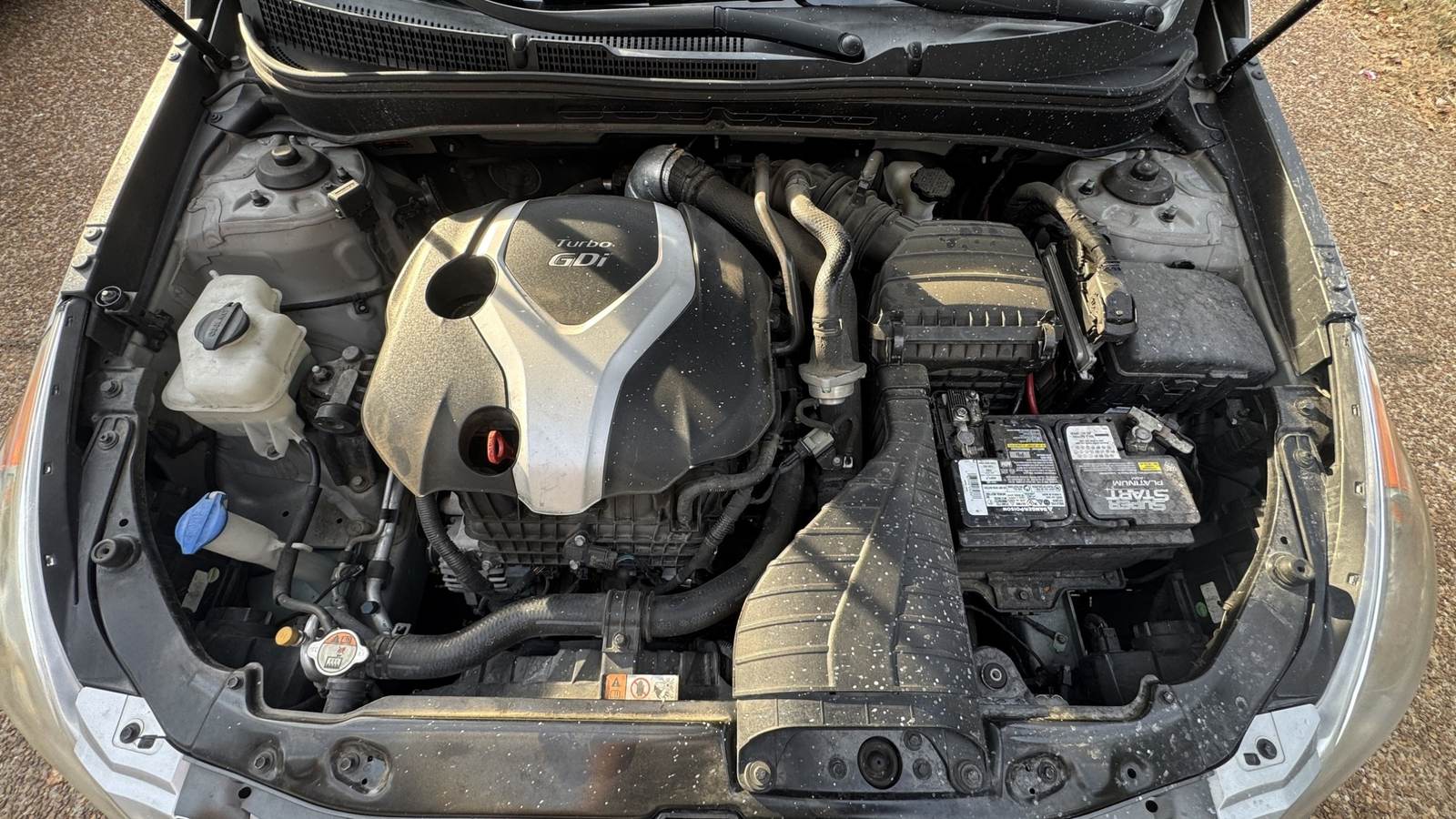 Dusty Hyundai engine bay before cleaning