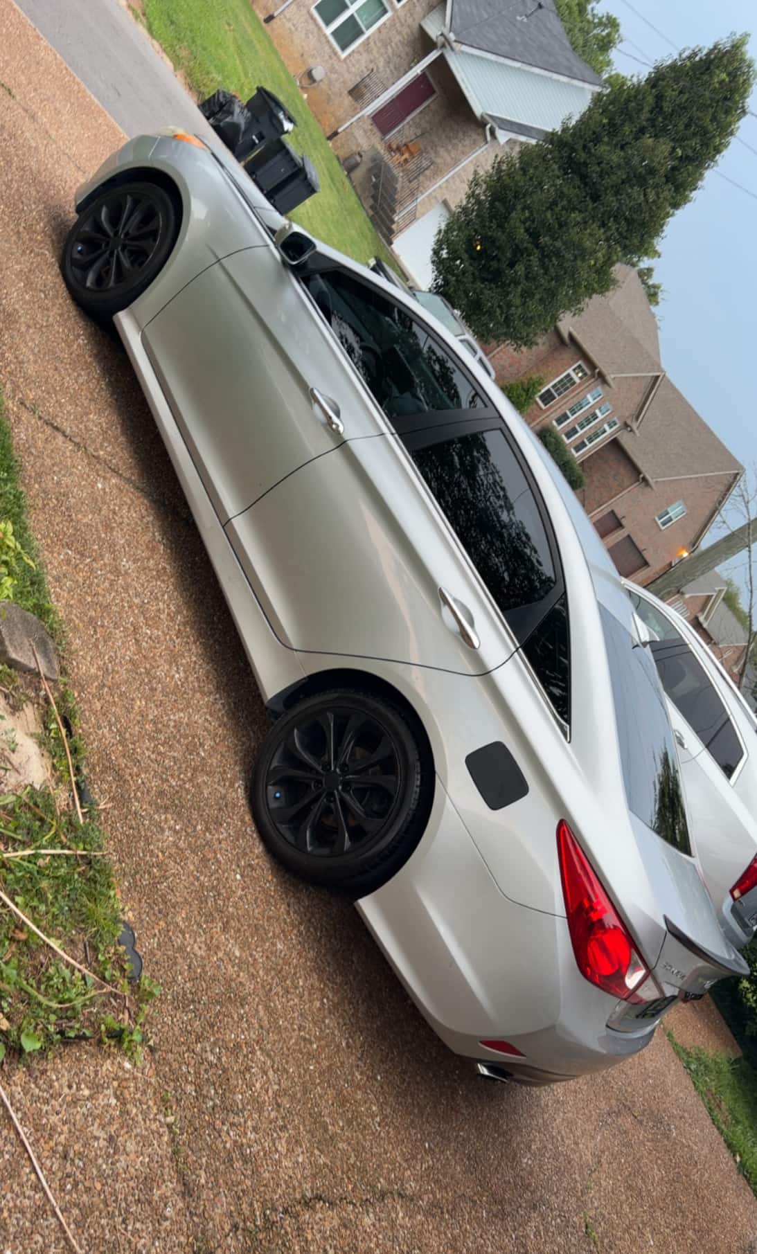 Silver Hyundai Sonata from the rear after a wash