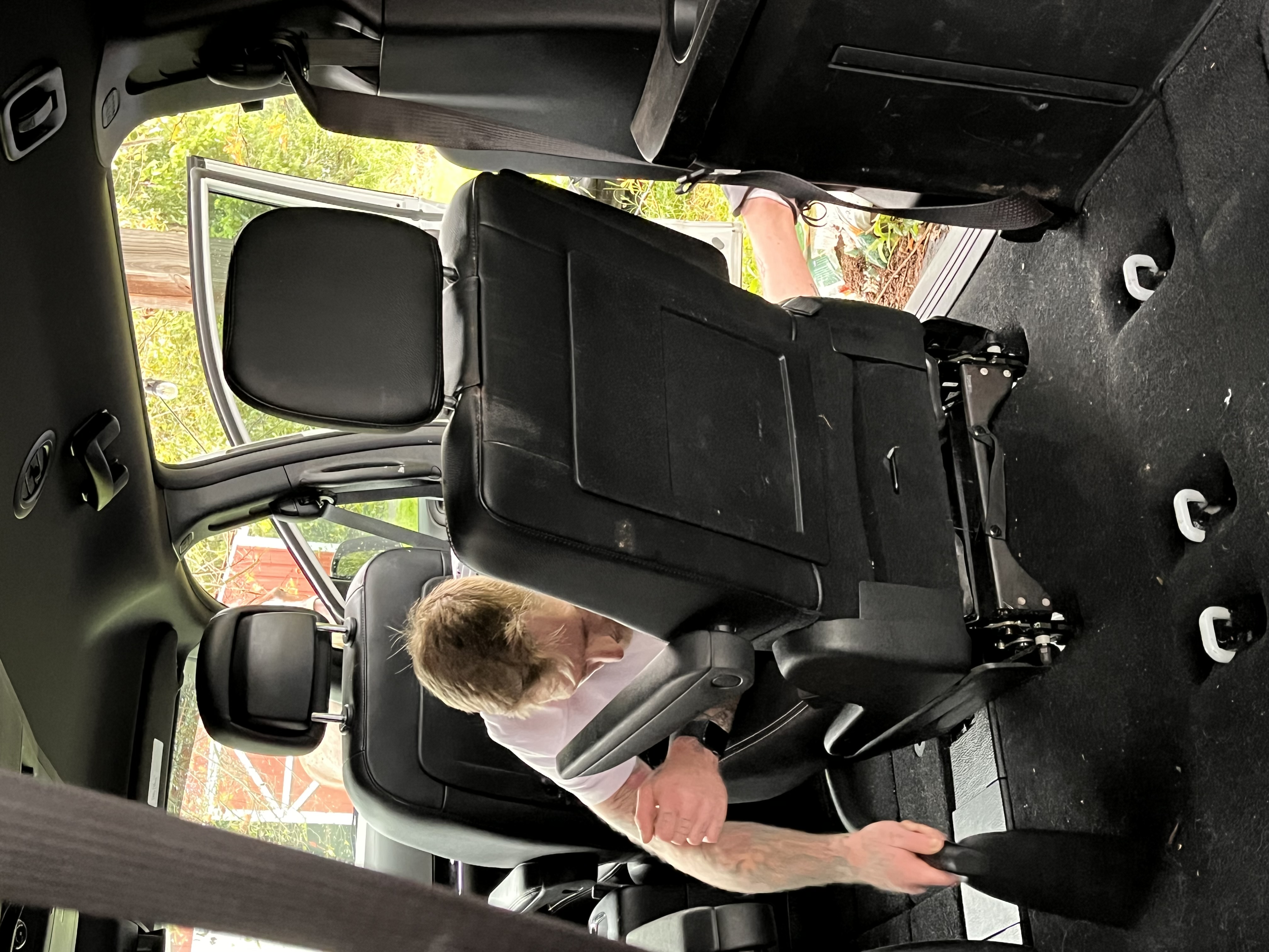 Jacob Carmody vacuuming under seats and hard-to-reach areas