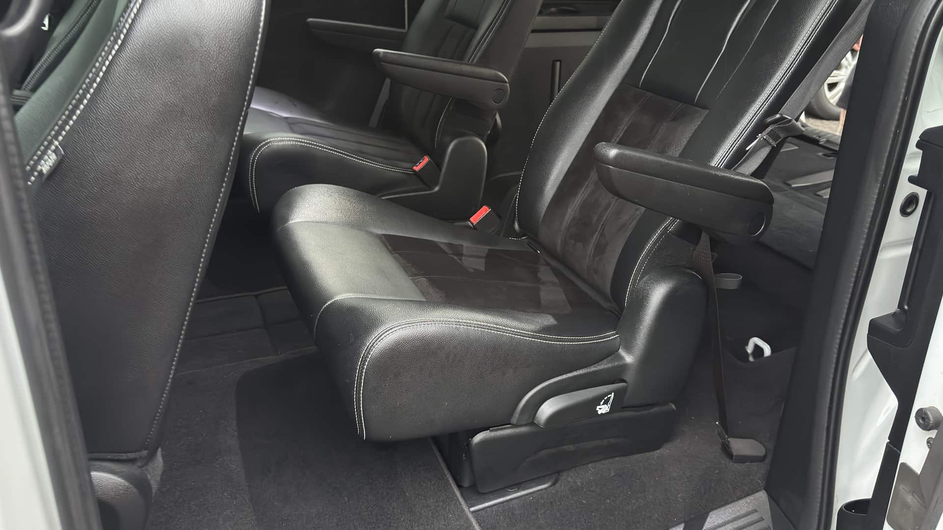 Minivan captain's chairs after cleaning, seen from the side door