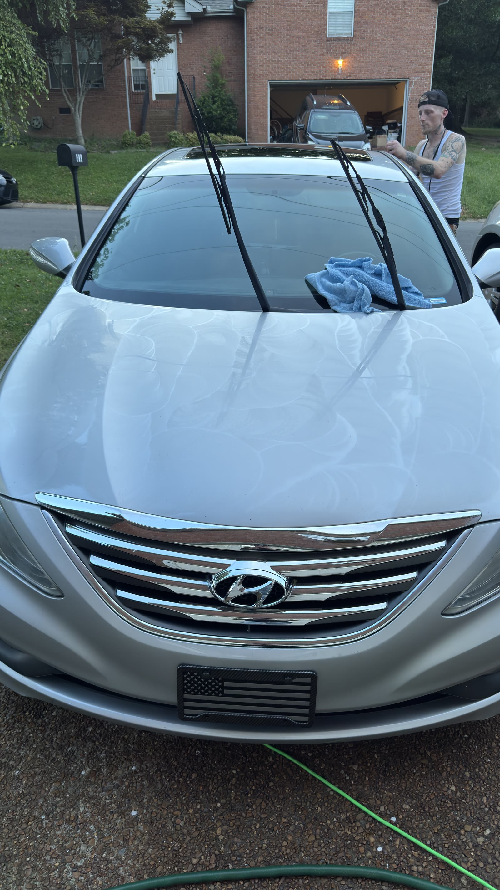 Silver Hyundai Sonata mid one-step polish — compound swirls on the hood, driveway paint correction.