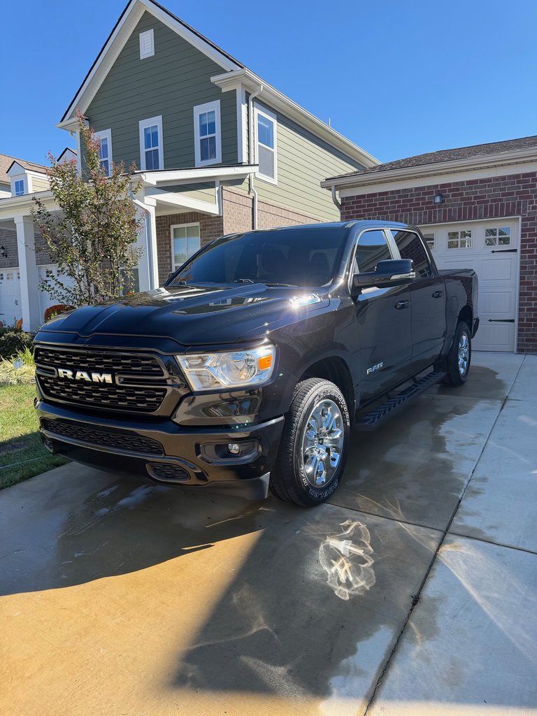 Black Ram 1500 after a mobile detail on a driveway