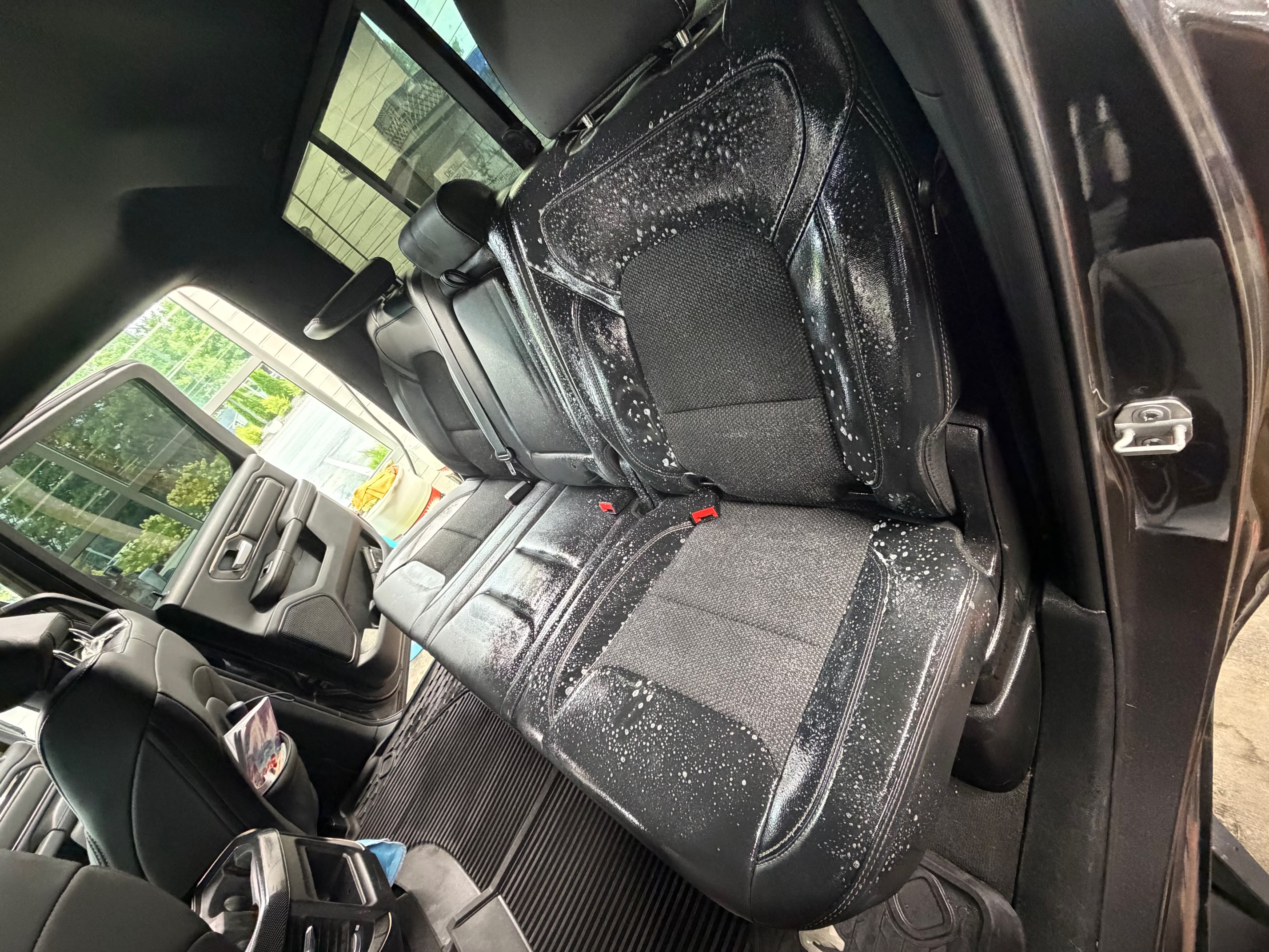 Foam cleaner applied to black leather truck seats