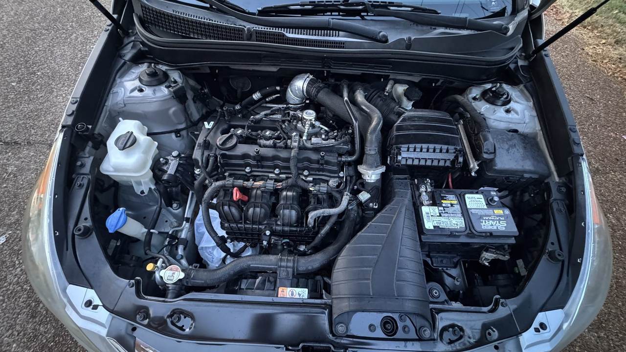 Engine cover off on a cleaned 2014 Hyundai Sonata 2.0T bay, before plastics and hoses are dressed.