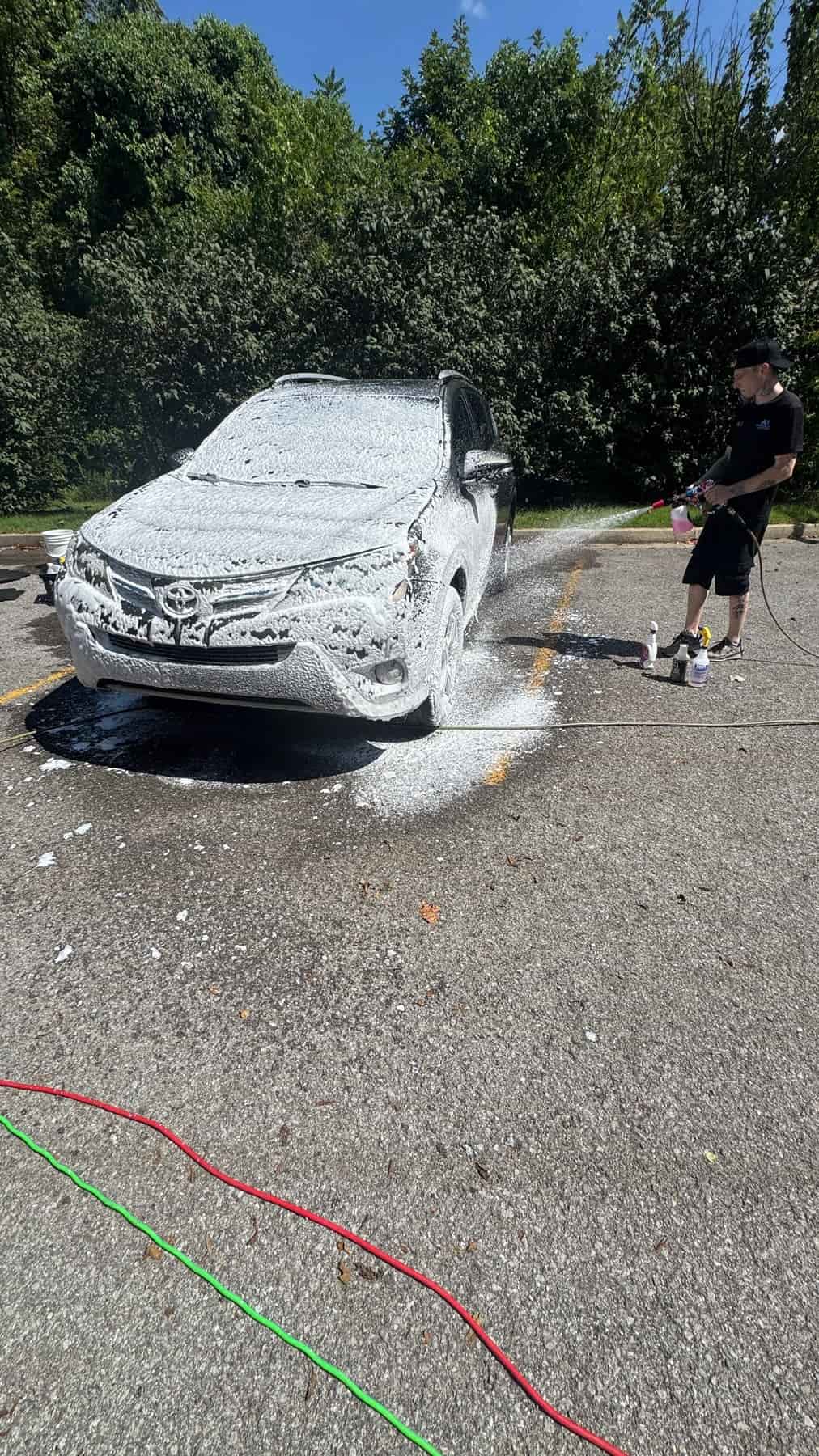 Detailer foaming a Toyota RAV4