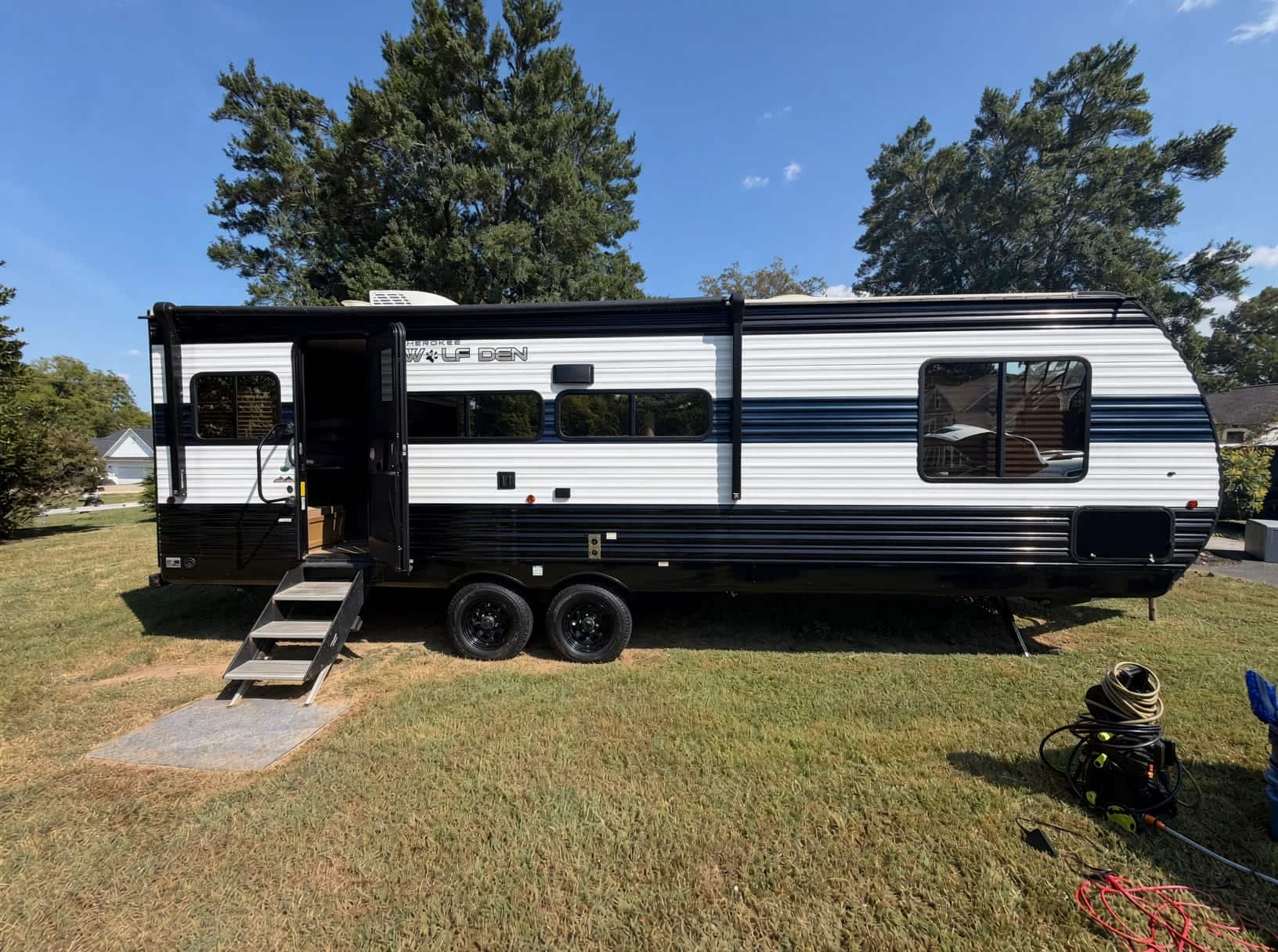 Travel trailer parked on grass after an exterior wash