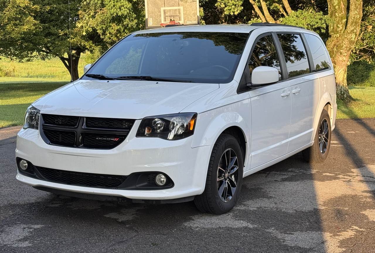 White Dodge Grand Caravan after a wash