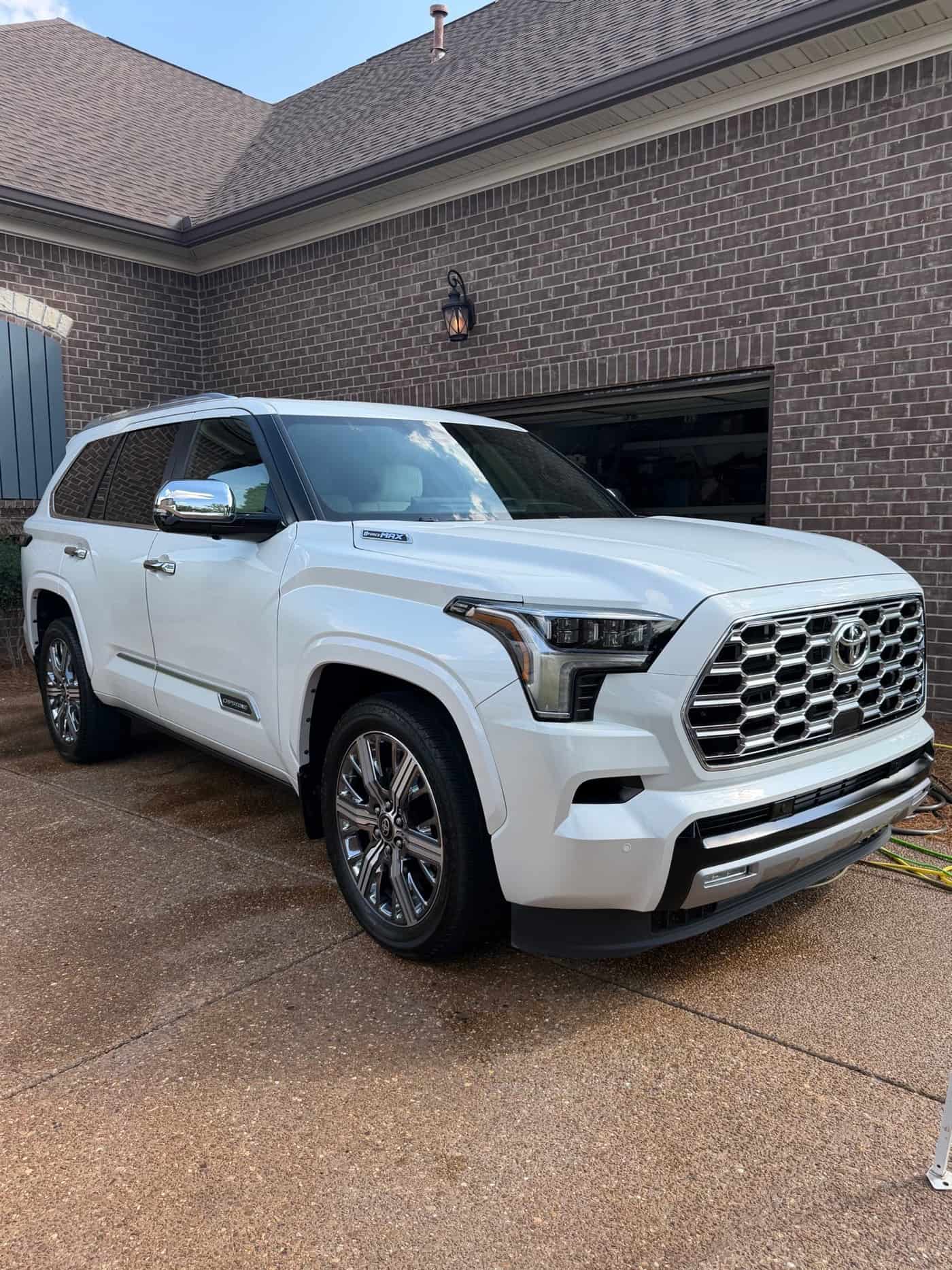 White Toyota Sequoia in front of a garage after a wash